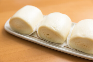 White fluffy buns placed on dish