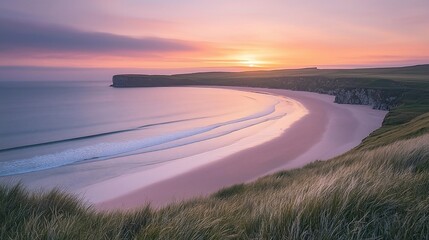 Dramatic sunrise over bay in Scotland with green cliffs, ocean waves; travel image