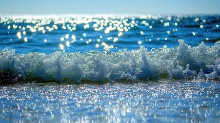 Sparkling Ocean Wave with Sun Reflections and Clear Blue Sky