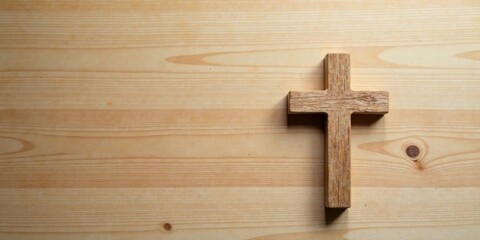 Rustic wooden cross on light wood background, peaceful and serene image