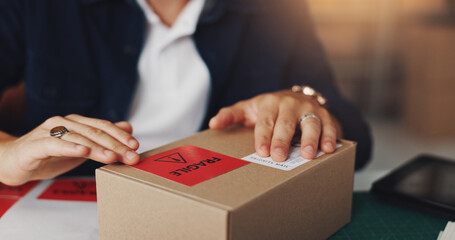 Hands, man and package with fragile sticker for distribution, order invoice and shipping information. Person, packaging and ecommerce warning of box delivery, courier caution and small business cargo