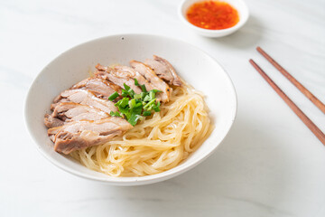 dried noodles with stewed duck in white bowl