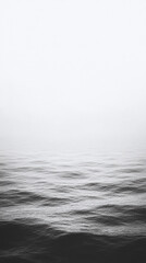 Fototapeta premium Monochromatic Sea Waves: A Serene Coastal View - Phone Wallpaper
