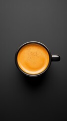 Minimalist espresso shot with golden crema, top view black coffee cup on dark background