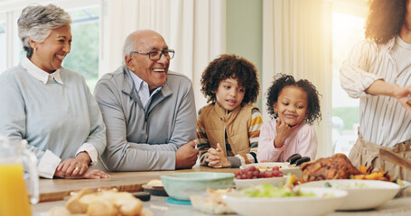 Family, food and happy with dinner in home for social gathering, celebration and weekend bonding. People, parents and grandparents with kids for holiday tradition, roast feast and connection in house