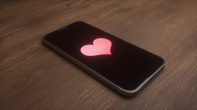 Heart shows on phone screen. Notification from dating app shows up on cell phone screen.