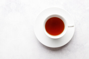 Cup of hot tea  on white table background.