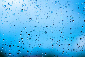 fun bright summery raindrops on a window glass