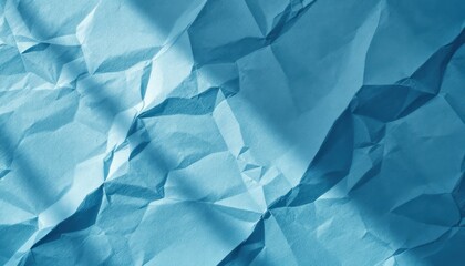 Obraz premium Crinkled blue paper texture with geometric fold patterns