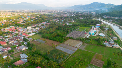 Aerial view of the village and vegetable garden in the morning.