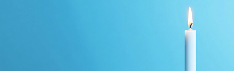 Candle Flame on Blue: A single white candle burns brightly, its flickering flame casting a warm glow against a vibrant blue backdrop. A simple yet powerful image that evokes a sense of hope.