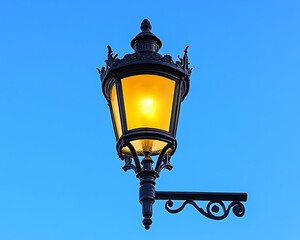 Fototapeta premium Ornate street lamp glows against blue sky
