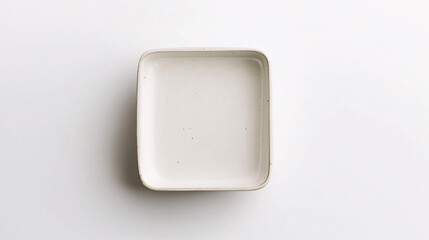 white ceramic rectangular dish on white background minimalist flat lay stock photo