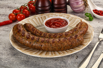 Grilled beef sausages with sauce