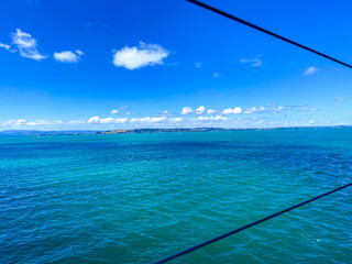 View of the blue tropic ocean from a ferry on the Island of Waiheke in Auckland, New Zealand.
