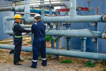 Plumbing engineers are hard at work inspecting the operation of a water system in an industrial factory.