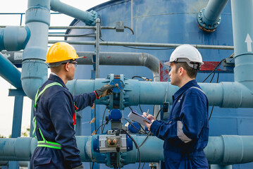 Plumbing engineers are hard at work inspecting the operation of a water system in an industrial...