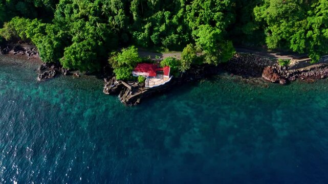 Aerial Drone tropical volcanic coastline of Camiguin Island the Philippines. Lush green Jungle, fertile soils, azure blue crystal clear waters ocean. 