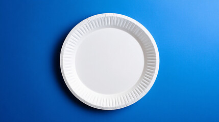 white paper plate on a blue background  minimalist table setting photography