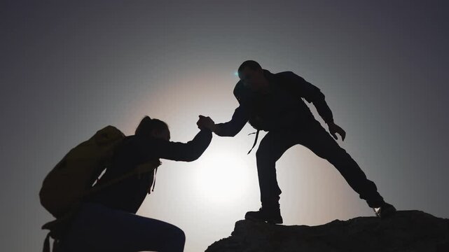 Leader offering help business teamwork silhouette. Helping hand in leadership concept. Business leader aids team concept. Successful leader helps in business ascent. Leader extends help business team.