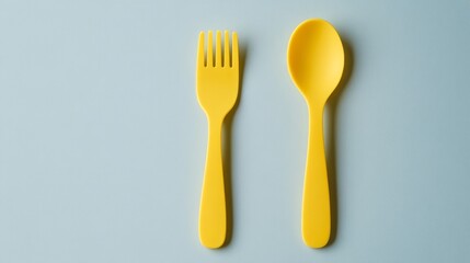 Green fork and spoon isolated on white background. Yellow colour objects. Eating. Kids fork and spoon. Kitchenwear. Tablewear. Simplicity. Scandinavian design. Product design. Comfort. Kids menu.