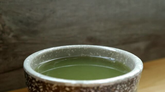 Footage of a Cup of Hot Japanese Matcha Green Tea with Steam