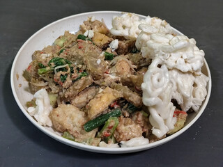 Rujak Cingur. Traditional Javanese food consisting of lontong with vegetables, peanut sauce, petis, tempeh, tofu, beef tongue, and crackers.