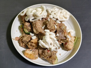 Rujak Cingur. Traditional Javanese food consisting of lontong with vegetables, peanut sauce, petis, tempeh, tofu, beef tongue, and crackers.