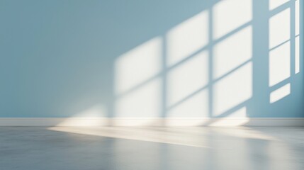 Obraz premium A serene interior space with light blue walls, showcasing shadows cast by window panes on the floor, creating a tranquil atmosphere.