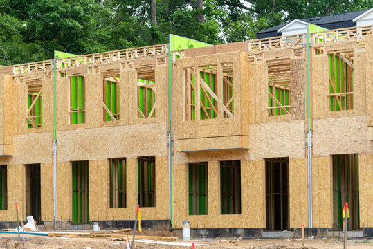 A view of a construction site with row-style housing under development showcasing modern urban planning and affordable housing efforts.