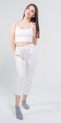 Cute young brunette standing on a white background. Copyspace