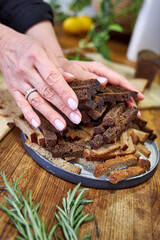 woman holding a plate with rye breadcrumbs, top view 
