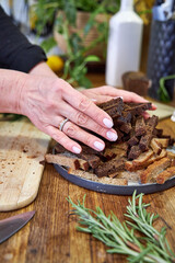 woman holding a plate with rye breadcrumbs, top view 