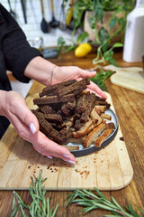 woman holding a plate with rye breadcrumbs, top view 