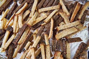 on the tray lay slices of gray and black bread for breadcrumbs