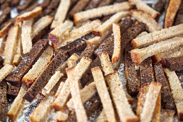 on the tray lay slices of gray and black bread for breadcrumbs