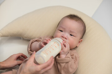 Baby drinking milk from a bottle