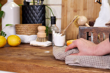 a woman washes white kitchen doors in a house