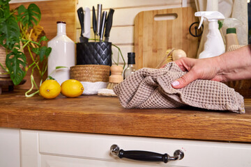 a woman washes white kitchen doors in a house