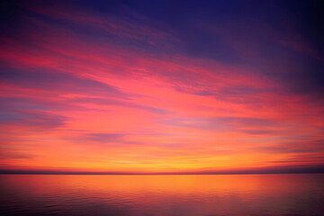 Fototapeta premium A vibrant sunset over calm waters, painting the sky with hues of orange and pink