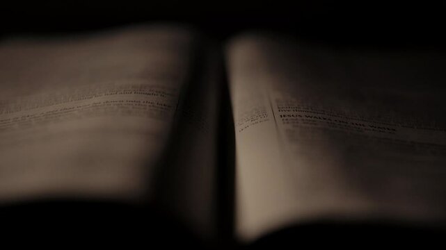Light rays shining and passing over a christian bible