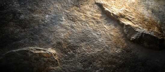 Textured stone surface with natural patterns and highlights capturing the essence of rugged terrain and geological formations.