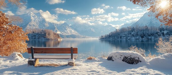 Scenic winter lake landscape with park bench under bright blue sky and mountains creating an inspirational and serene atmosphere