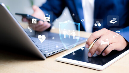 Insurance concept. Businessman using a computer to insurance online for family and life, financial, car, travel, and health insurance.