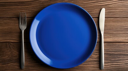 Setting a beautifully arranged blue plate for dinner rustic wooden table food presentation cozy atmosphere top view culinary art