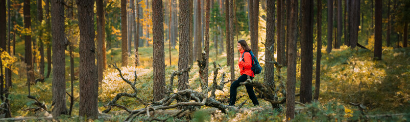 Active Young Adult Beautiful Caucasian Lady Woman Dressed In Red Jacket Walking In Autumn Green Forest. Active Lifestyle In Nature © Great Brut Here