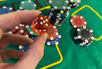 Poker Chips on a gaming table with dramatic lighting