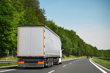 Truck hauling trailer on city highway