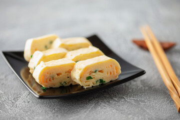 Tamagoyaki, Japanese rolled omelette in plate on the table