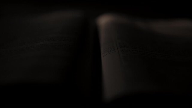 Light rays shining and passing over a christian bible